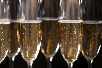 Glasses of champagne on dark background, closeup