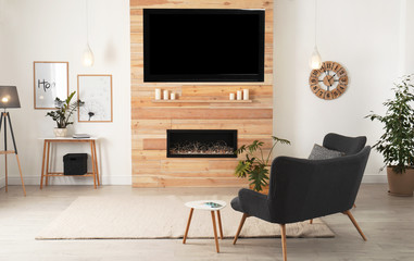 Living room interior with decorative fireplace in wooden wall