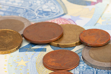 Micro loan offer. Little bit of European Union money. Metal coins of and paper banknotes design. Euro cash closeup on white background. Limited depth of field