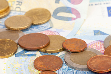 Micro loan offer. Little bit of European Union money. Metal coins of and paper banknotes design. Euro cash closeup on white background. Limited depth of field