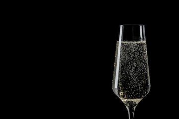 Glass of champagne on black background, space for text