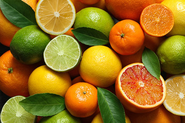 Many different citrus fruits as background, top view