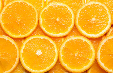 Juicy orange slices as background, top view. Citrus fruit
