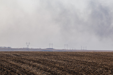 Fototapeta na wymiar Smoke over the field