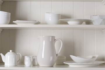 Obraz na płótnie Canvas Stylish storage stand with different ceramic dishware at home