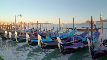 Fototapeta na wymiar 15268_Lots_of_gondolas_docking_on_the_Venice_canal_in_Venice_Italy.jpg