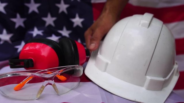 Labor Day ideas: hats and various labor protective equipment is placed on the flag of the United States footage slow motion
