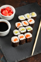 Japanese sushi on a rustic dark background.
