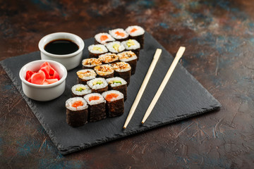 Japanese sushi on a rustic dark background.