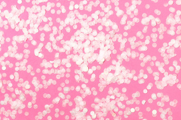 Flat lay paper round confetti on pastel pink background top view. Festive holiday background, concept of party, birthday, christmas or new year. Creative holiday concept minimal style