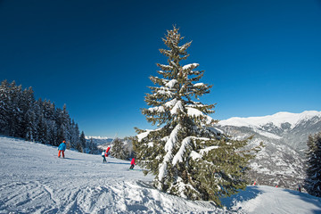 Skiers on a piste in alpine ski resort