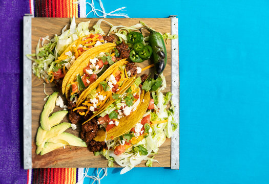 Cinco: Five Tacos On Board With Jalapenos And Avocado