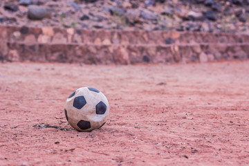 deflated football ball sport concept in third world poor slum ghetto Middle East desert environment...