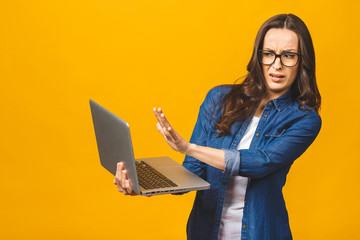 Young caucasian woman using laptop over isolated background with open hand doing stop sign with...
