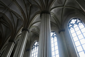 View of gothic medieval cathedral interior with columns and large windows. The Church of Sts. Olha...