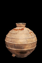 Antique clay pottery isolated on black background