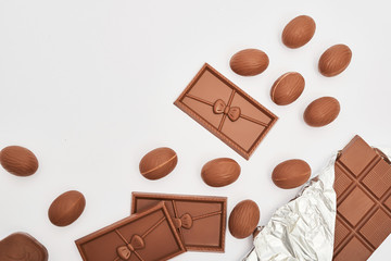 Delicious chocolate Easter bunny and eggs on white background top view copy space. Easter Greeting Card Template. Happy easter concept. Chocolate on white background. Chocolate Bars and Easter Sweets