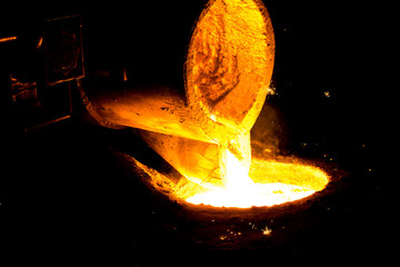 metal casting process with red high temperature fire in metal part factory