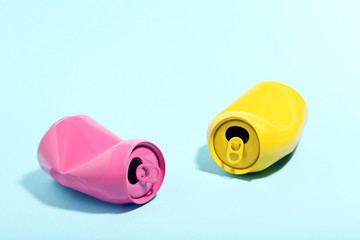 Colorful aluminum cans on blue background. Minimalism concept