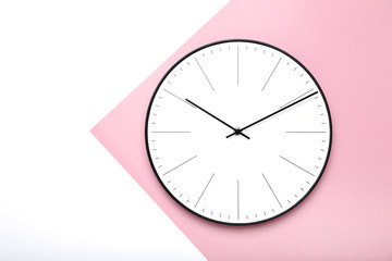 Round clock on colorful background