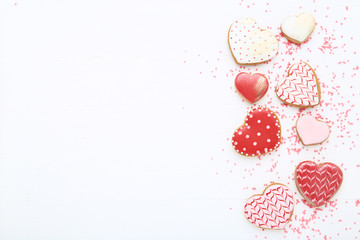 Valentine day heart shaped cookies with sprinkles on white wooden table