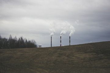 industrial factory and smoke from chimney on a background of blue sky