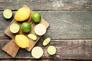 Fototapeta na wymiar Ripe lemons and limes on grey wooden table