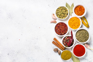 Colored indian spices on white table.