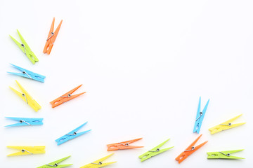 Colorful plastic clothespins on white background