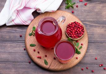 Fresh cranberry drink on wooden background. Still life