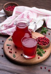 Fresh cranberry drink on wooden background. Still life