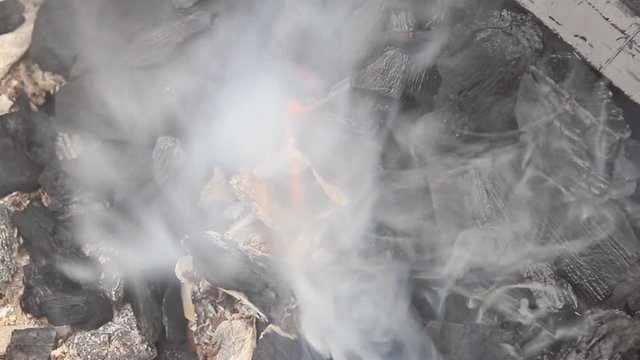 Flaming burning charcoal grill in the background