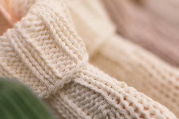 Fototapeta na wymiar Hangers with women's and men's wear in shop. Sweaters of large knitting