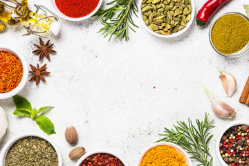 Spices and herbs on white stone table.