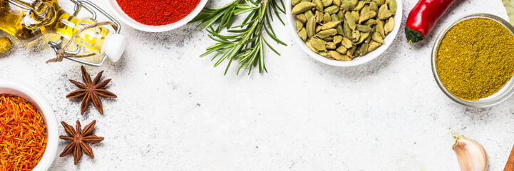 Spices and herbs on white stone table.