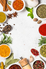 Spices and herbs on white stone table.