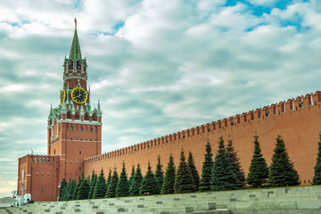 View of the Kremlin's Spasskaya Tower with a clock and the Kremlin Red Wall in Moscow