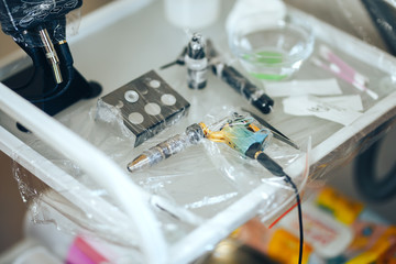woman prepare instruments for permanent makeup to work use wrap tape for sterility, tools for tattoo ready to use