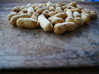 peanuts in shell on wood background