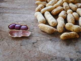peanuts in shell on wood background