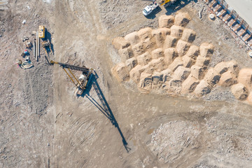 Koper equipment for installation of construction piles in the ground, aerial top view.