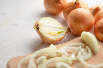 Sliced fresh onions on wooden background. Vegetables for a healthy diet. Vegan food.