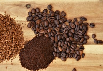 grain, ground and granules of coffee on a wooden background