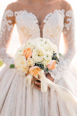 Wedding bouquet of flowers held by bride closeup