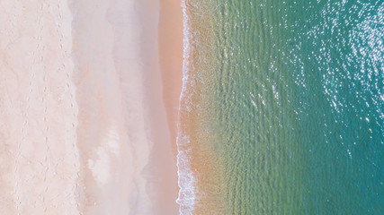 Aerial view of Beach with shade emerald blue water and wave foam on tropical sea