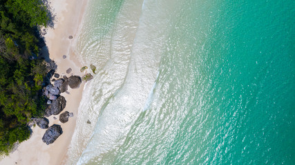 Aerial view of Beach with shade emerald blue water and wave foam on tropical sea