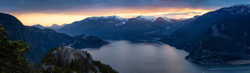Naklejka na ściany i meble Scenic Panoramic Landscape view of the Beautiful Canadian Nature from the top of the Mountain during a colorful sunset. Taken in Squamish, North of Vancouver, BC, Canada.