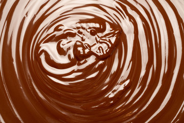 Macro of Melted milk or dark chocolate swirl background