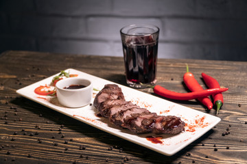 georgian grilled kebab meat with pepper and wine on wooden background;