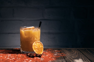 orange cocktail with cinnamon and straw on brick background  © goami